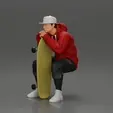 gif-collection-10.gif man in hoodie and cap sitting and putting his hand on the skateboard